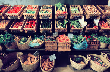 vegetables and fruits in wicker baskets in greengrocery