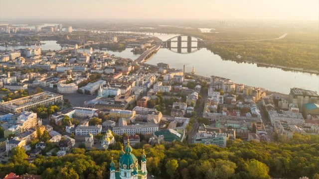 Kyiv \ Kiev , Ukraine. Aerial hyperlapse of Kiev old city center. Flying over St. Andrew's Church and Podol at sunrise. UHD 4K