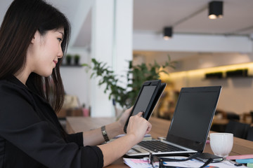 businesswoman use tablet at workplace. young woman working on touchpad at office. freelancer connect online network communication at cafe coffee shop.