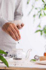 Male hands with dry black tea falling