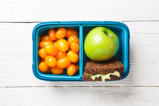 Picture of cherry tomato,apple, sandwich in lunchbox