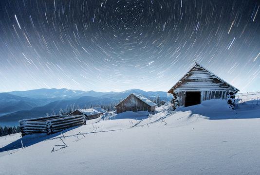 chalets in the mountains at night under the stars. Magic event in frosty day. In anticipation of the holiday. Dramatic scenes