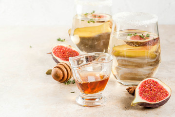 Fall cold sweet white wine cocktail with fig, plum, honey and thyme, copy space