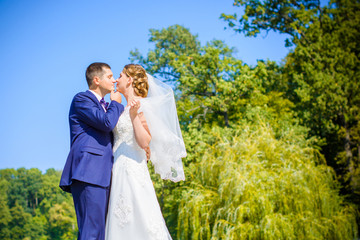 Wedding on a warm, sunny day in a beautiful European park. The groom is younger than the bride.Plus size woman- bride . A nice and beautiful couple have a happy day
