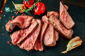 Roast beef cut in slices with tomatoes