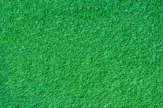 Abstract background, texture of artificial green grass, top view