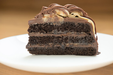 banana caramel chocolate cake. tasty deliciouse dessert on white plate. homemade bakery pastry