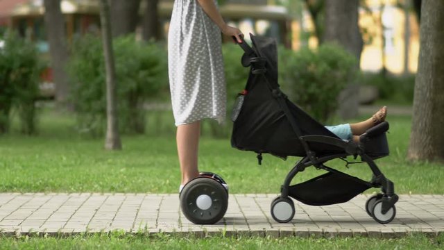 Woman drives gyroscooter and carries baby carriage