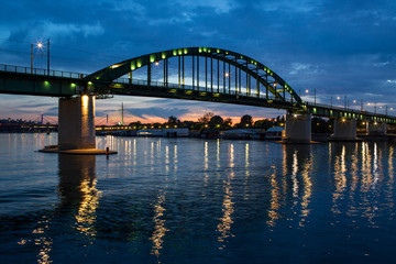 Fototapeta na wymiar Panorama Night View Of A Bridge Over River Sava A Right Tributary Of The Danube In Belgrade Capital City Of Serbia