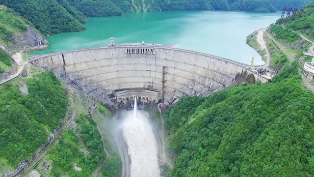 Takeoff Flying over Dam in Mountain Landscape Aerial 4k video. Green Alternative renewable Energy Electric Power technology scene.