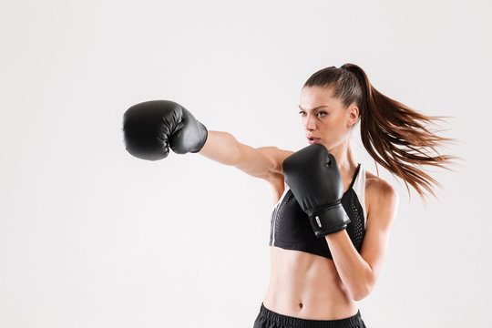 Portrait of a young motivated woman doing boxing
