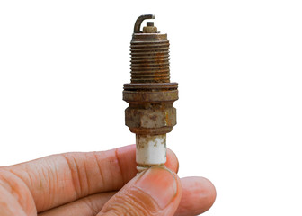 Mechanic holds a spare part spark plug in his hand. Auto part spark plug close-up on a white background.