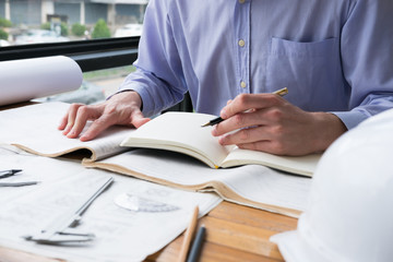 architect working on construction plan at office. engineer inspect blueprint at workplace. man...