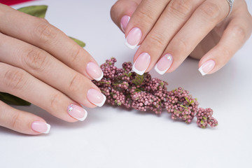 Natural nails with gel polish applied. Ideal manicure and women's hands.