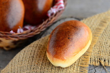 Home fluffy patties. Baked patties with filling. Rustic style. Closeup