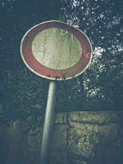 Old dirty and weathered traffic sign for entrance forbidden