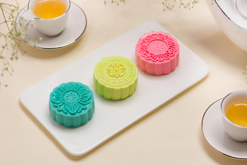 Traditional mooncakes on table setting. Snowy skin mooncakes. Chinese mid autumn festival foods.