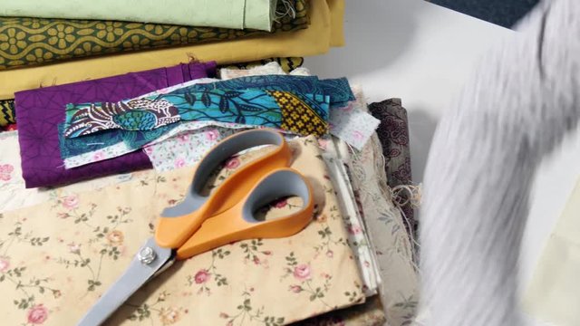 seamstress woman hands sewing for finish a quilt.