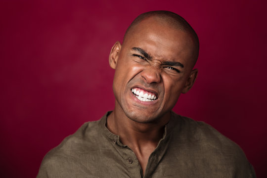 Close up portrait of angry african man looking at camera