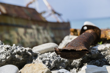 Close-Up Of Severed Rusty Pipe Washed-Up On Greek Beach