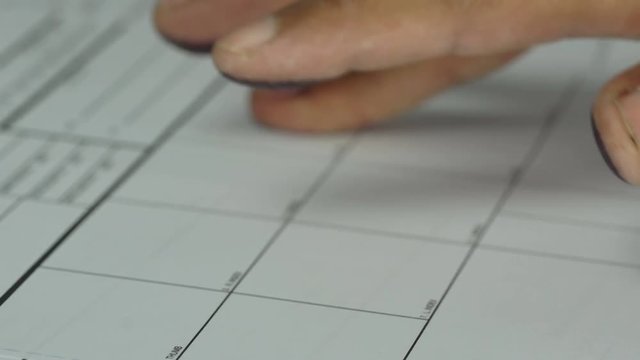 A man is being finger printed for either a crime  on a legal document form
