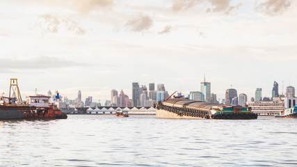 Boat in the Chao Phraya River has a building as a background image