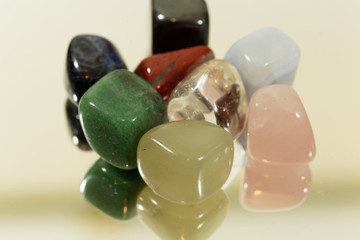 Tumbled gemstones on a mirror