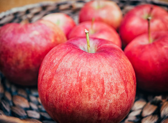 wooden basket with big red apples. Macro shot