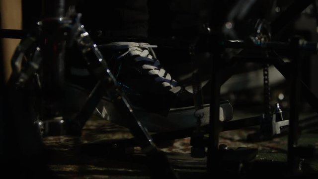 Close up foot of drummer using drum pedal during live performance
