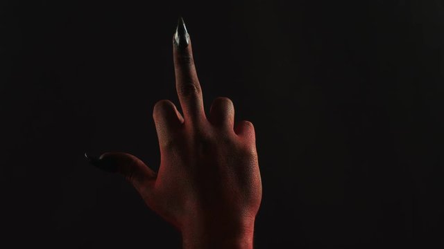 Fuck sign by demon hand.