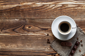 pie on bedding with the cup of coffee on a background a wooden table