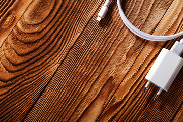 Cable phone chargers on wood background