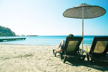 Man relaxing on a beach back view