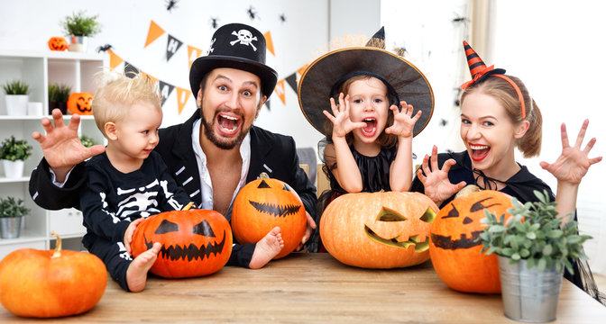 happy family mother father and children in costumes   on  Halloween
