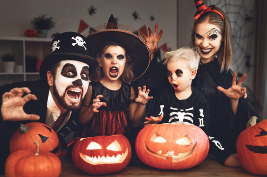 happy family mother father and children in costumes and makeup on  Halloween