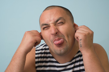 man shows his finger on the tongue