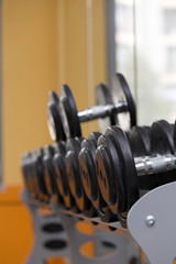 Fototapeta na wymiar dumbbells row in fitness center