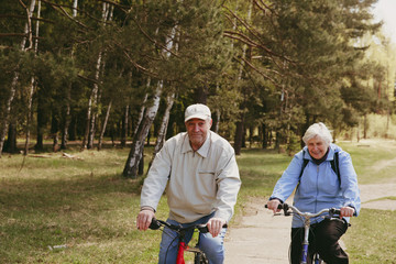 Senior couple riding bikes in nature