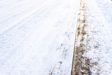 Background with snow on road in winter and pavement, texture