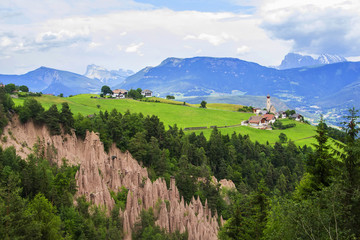 background view landscape Alpine village on a plateau surrounded by mountains Rennon in Tirol, Italy