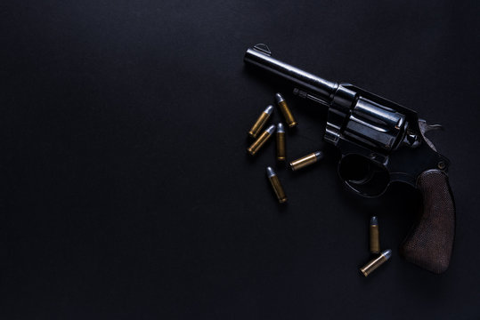 Gun With Bullets On Black Background