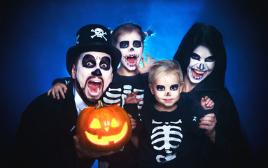 Fototapeta premium happy family mother father and children in costumes and makeup on Halloween