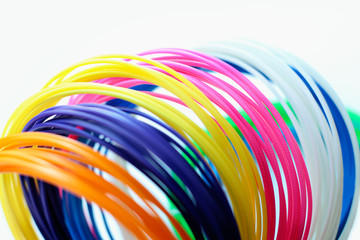 Kit ABS plastic for 3D printer and pen on white background