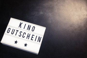 Kino gutschein on word board in cinema theme