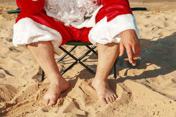 Santa Claus is resting on the beach.