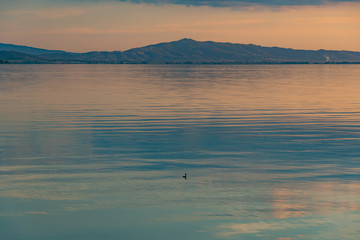 sunset over Lake Trasimeno in Umbria, with rippled water