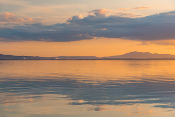sunset over Lake Trasimeno in Umbria, with rippled water