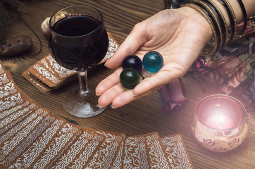 Fortune teller female hands and tarot cards on wooden table. Divination concept.