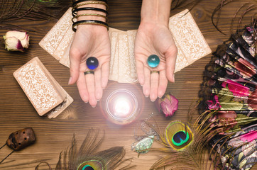 Fortune teller female hands and tarot cards on wooden table. Divination concept.