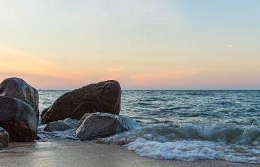 Wave splash in the sea against stone